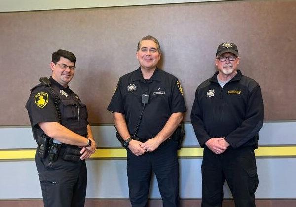 Three male officers of the Black Hawk Police Department pose for a picture together.